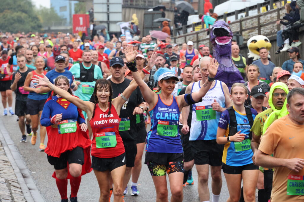 Runners learning about the Three Tumours Brain Tumour Charity.